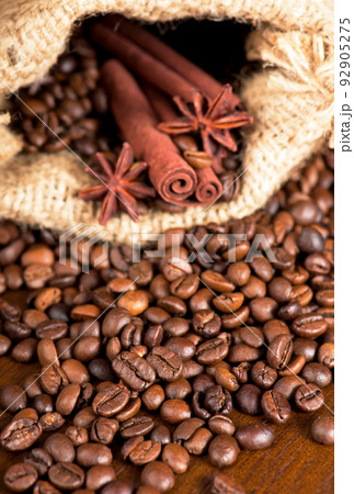 coffee beans, cinnamon sticks and star anise dark background coffee beans, cinnamon sticks and star anise dark background 92905275