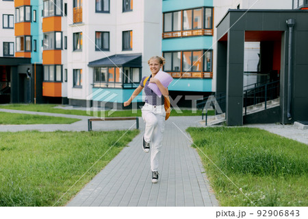 A happy student runs to school, hurries to classes, rejoices in the new academic year. Back to school 92906843