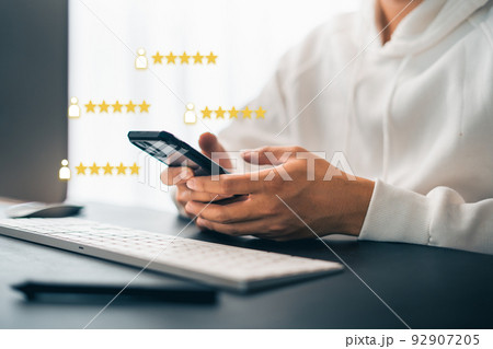 Hand and Phone With Five Star Rating Hand and Phone With Five Star Rating 92907205