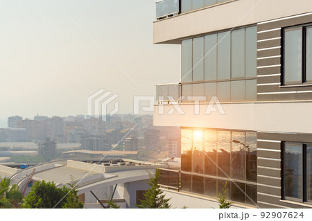 Modern high-rise residential building with glass panoramic windows. 92907624