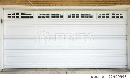 Panorama White sectional garage door with window panels and concrete driveway Panorama White sectional garage door with window panels and concrete driveway 92909943