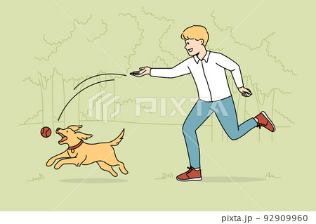 Happy boy playing with dog in park 92909960