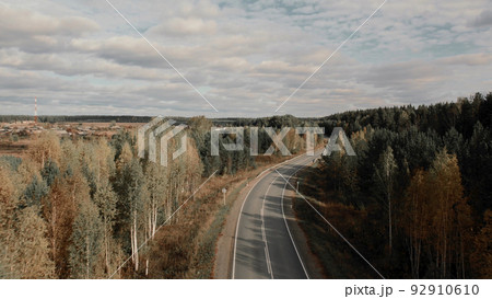 Asphalt road with traffic cars between forest in Ural Asphalt road with traffic cars between forest in Ural 92910610