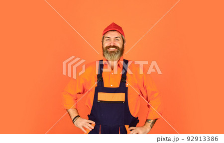 man wear boilersuit. bearded worker in overalls. Confident Mature Mechanic. Portrait Of Repairman. Worker in storehouse. Caucasian workman in storeroom. Mad repairman concept 92913386
