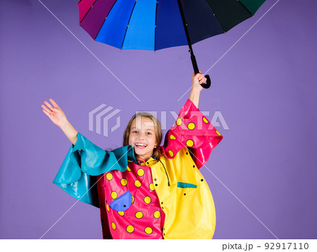 Enjoy rainy weather with proper garments. Waterproof accessories for children. Waterproof accessories make rainy day cheerful and pleasant. Kid girl happy hold colorful umbrella wear waterproof cloak Enjoy rainy weather with proper garments. Waterproof accessories for children. Waterproof accessories make rainy day cheerful and pleasant. Kid girl happy hold colorful umbrella wear waterproof cloak 92917110