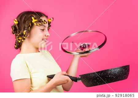 Perfect for pancakes. Culinary and house duties. Girl hold Frying Pan. Little kid hold pan cooking meal. Small girl with curlers in hair. Pin up style. Home utensils. Kitchen accessory. Healthy food Perfect for pancakes. Culinary and house duties. Girl hold Frying Pan. Little kid hold pan cooking meal. Small girl with curlers in hair. Pin up style. Home utensils. Kitchen accessory. Healthy food 92918065