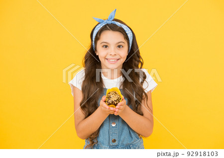Treat someone with sweets. Yummy cupcake. Homemade muffin. Bakery confectionery concept. Kid girl hold muffin. Gluten free recipe. Delicious cupcake. Little child with muffin on yellow background Treat someone with sweets. Yummy cupcake. Homemade muffin. Bakery confectionery concept. Kid girl hold muffin. Gluten free recipe. Delicious cupcake. Little child with muffin on yellow background 92918103