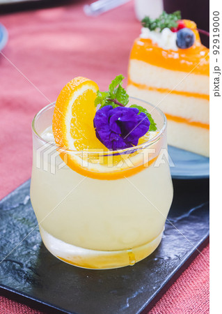 A glass of Japanese iced yuzu fruit tea topped with sliced yuzu orange and mint. A glass of Japanese iced yuzu fruit tea topped with sliced yuzu orange and mint. 92919000