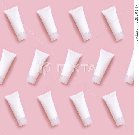White cream tube on light pink top view pattern. Cosmetic Mockup. Skincare product White cream tube on light pink top view pattern. Cosmetic Mockup. Skincare product 92920147