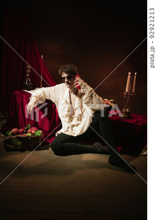 Artistic portrait of young handsome man in image of famous historical character, medieval person isolated on dark vintage background. Retro style Artistic portrait of young handsome man in image of famous historical character, medieval person isolated on dark vintage background. Retro style 92921213