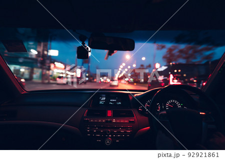 Driver drive a car on night city with cyber punk neon traffic light. 92921861