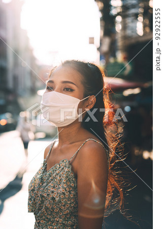 Portrait authentic asian adult woman tan skin wear face mask for self care form corona virus. 92922555