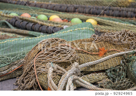 Colored nets and ropes on a quay. 92924965
