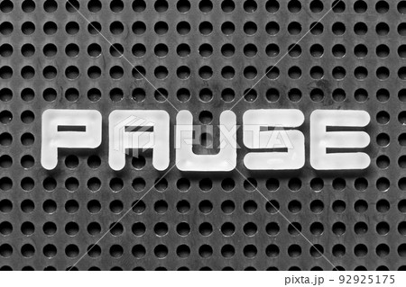 White alphabet letter in word pause on black pegboard background 92925175