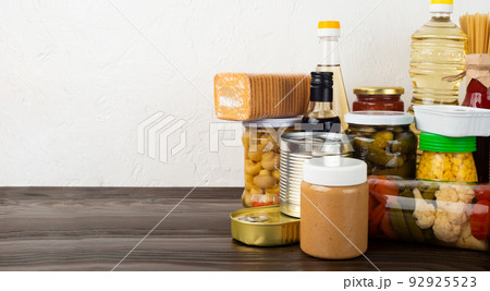 Emergency survival food set on dark wooden kitchen table Emergency survival food set on dark wooden kitchen table 92925523