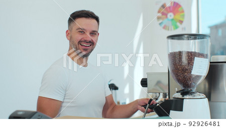 Man barista is making a cappuccino in a coffee shop bar. Coffee shop concept. Man barista is making a cappuccino in a coffee shop bar. Coffee shop concept. 92926481