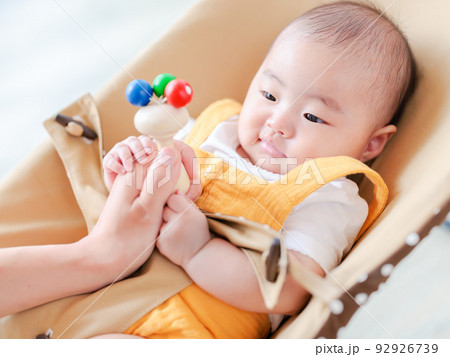ガラガラに興味を示す赤ちゃん　ママの手を掴む　ファーストトイ　木の玩具　聴覚、色覚の発達　追視 92926739