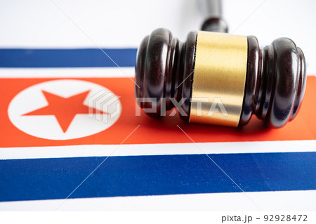 North Korea flag with gavel for judge lawyer. Law and justice court concept. North Korea flag with gavel for judge lawyer. Law and justice court concept. 92928472