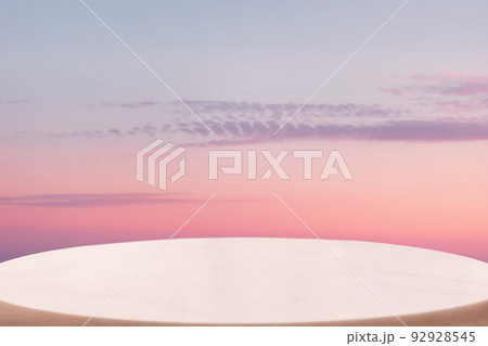 A white marble oval pedestal or table surface on a pink twillight sky background. Copy space. The concept of a product demonstration template A white marble oval pedestal or table surface on a pink twillight sky background. Copy space. The concept of a product demonstration template 92928545