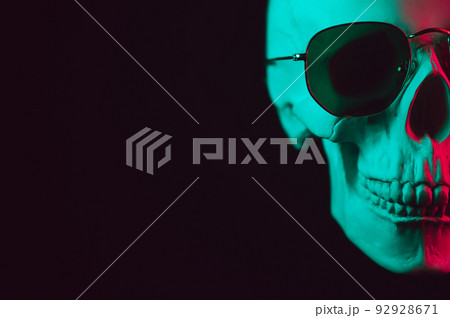 human skull wearing sunglasses with pink green neon light human skull wearing sunglasses with pink green neon light 92928671