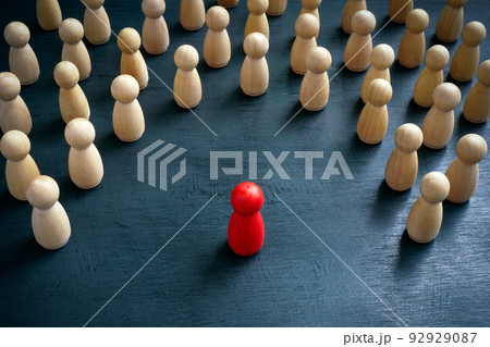 Discrimination and inclusion concept. The wooden figurines surrounded the red one. 92929087