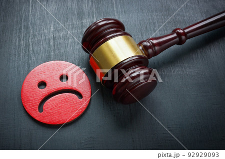 Unhappy smiley and gavel. Discrimination and Bullying law concept. 92929093