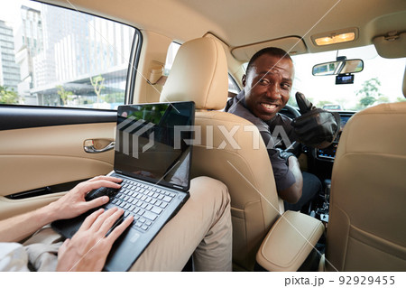 Taxi Driver Turning Back to Passenger Taxi Driver Turning Back to Passenger 92929455
