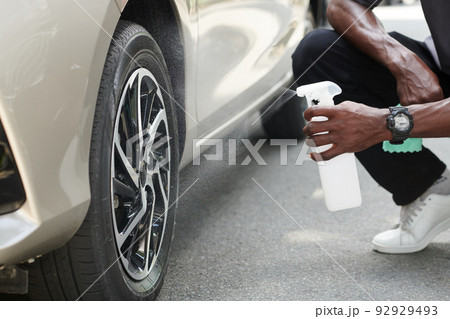 Car Owner Using Anti Dust Spray 92929493