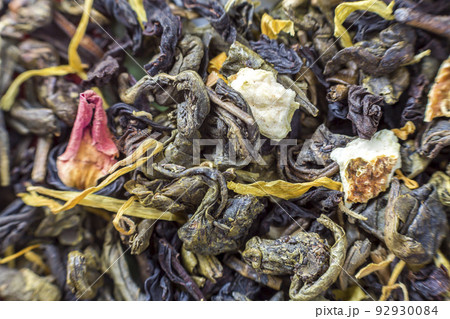 Close-up of dry tea herbal petals abstract dark colorful background. Healthy lifestyle, natural antioxidant drink, aromatherapy concept. Close-up of dry tea herbal petals abstract dark colorful background. Healthy lifestyle, natural antioxidant drink, aromatherapy concept. 92930084