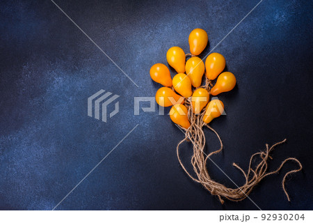 The concept idea in the form of balloons on ropes is made of yellow tomatoes The concept idea in the form of balloons on ropes is made of yellow tomatoes 92930204