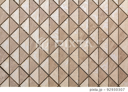 Beige tiles wall or floor with light floral decoration. Repeating graphic design, flat surface, geometrical background. Beige tiles wall or floor with light floral decoration. Repeating graphic design, flat surface, geometrical background. 92930307