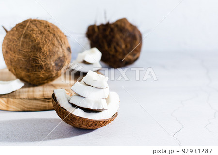 Pieces of ripe coconut on the table. Tropical fruits. Natural source of antioxidants 92931287