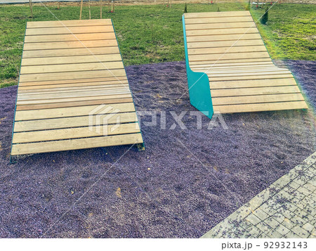 texture, background. 3d volumetric background, pink stones. there is a wooden bench on the road for people to rest. two wooden benches texture, background. 3d volumetric background, pink stones. there is a wooden bench on the road for people to rest. two wooden benches 92932143