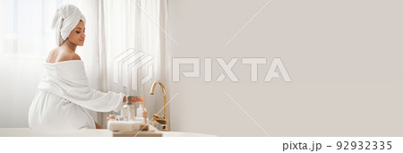 Relaxed Woman Enjoying Bodycare Rituals, Sitting In Bathroom, Copy Space Relaxed Woman Enjoying Bodycare Rituals, Sitting In Bathroom, Copy Space 92932335
