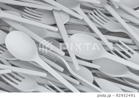 Heap of disposable utensils like spoon, fork and knife on white background. 92932491