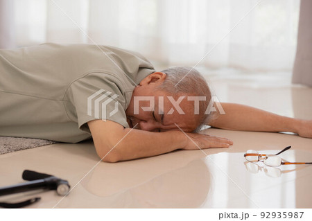 Asian senior male falling on the ground while walk with walker at home. Asian senior male falling on the ground while walk with walker at home. 92935987