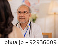 Senior Asian physician Watch as female patients discuss their health issues as you sit. 92936009