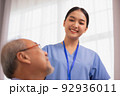 Happiness Cheerful elderly men talking with female caregiver nurse doctor having health checking consult at home. 92936011