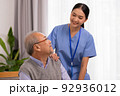 Happiness Cheerful elderly men talking with female caregiver nurse doctor having health checking consult at home. 92936012