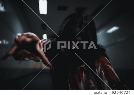Horror bloodthirsty ghost girl hair covering face and eye reach arm out Horror bloodthirsty ghost girl hair covering face and eye reach arm out 92940724