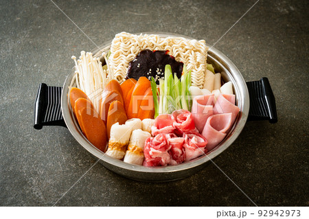 Budae Jjigae or Budaejjigae (Army stew or Army base stew). It is loaded with Kimchi, spam, sausages, ramen noodles and much more 92942973