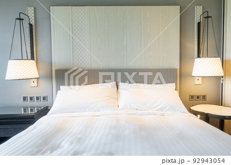white pillows decoration on bed in bedroom 92943054