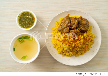 Beef Biryani or Curried rice and beef - Thai-Muslim version of Indian biryani, with fragrant yellow rice and beef Beef Biryani or Curried rice and beef - Thai-Muslim version of Indian biryani, with fragrant yellow rice and beef 92943102