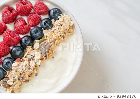 homemade yogurt bowl with raspberry, blueberry and granola homemade yogurt bowl with raspberry, blueberry and granola 92943176