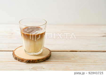 Dirty coffee, cold milk topped with hot espresso coffee shot Dirty coffee, cold milk topped with hot espresso coffee shot 92943725