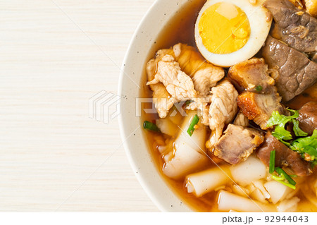 paste of rice flour or boiled Chinese pasta square in clear soup 92944043