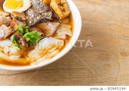 paste of rice flour or boiled Chinese pasta square in clear soup 92945194