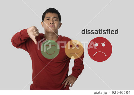 Young man choosing sadness emotion face screen. customer experience dissatisfied 92946504