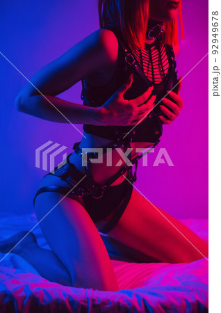 slender girl with a sexy body in erotic underwear poses beautifully on a bed in a bedroom 92949678