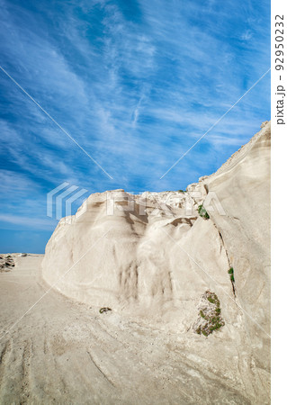 White rocks of Sarakiniko beach, Aegean sea, Milos island , Greece. No people, empty cliffs, summer sunshine, lunar landscape, deep blue sky, clouds 92950232